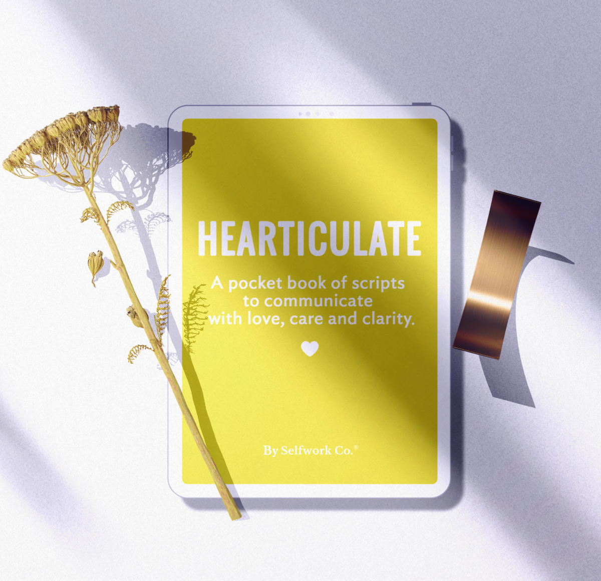 Digital flatlay of the Hearticulate journal on a tablet, styled with a dried flower and metallic tape in soft shadows.