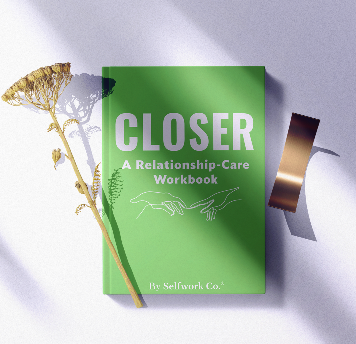 Artistic flatlay of Closer Relationship-Care Workbook hardcover with floral props and soft sunlight for lifestyle presentation.

