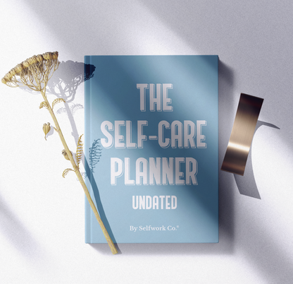  Flatlay of The Self-Care Planner (physical) with natural props, highlighting the book’s premium quality and soft tone.
